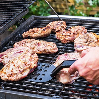 An image of a person using a charcoal grill