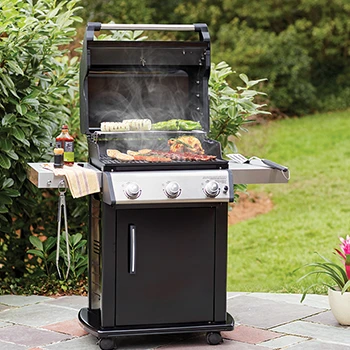 An image of a cooking gas grill in a backyard