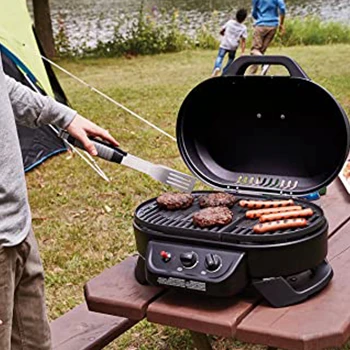 An image of a man cooking using a grill with a good cooking area