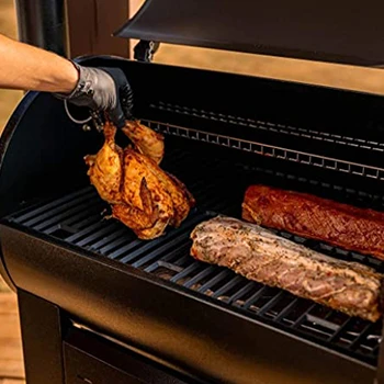 An image of a man using a pellet grill with a good cooking area