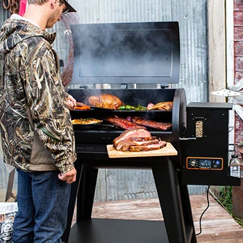 An image of a man using a pellet grill with a good cooking capacity