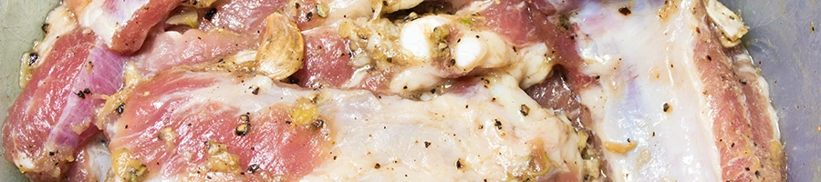 A close up image of marinated meat