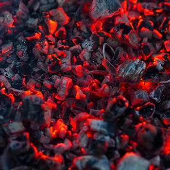A close up image of burning charcoal as a fuel for fire pit grill
