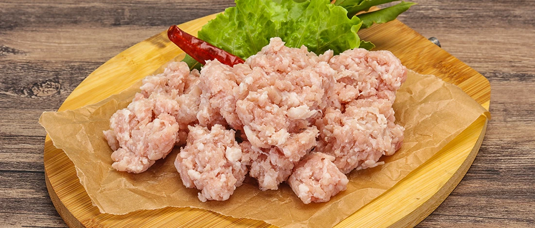 An image of a ground turkey meat on top of a wooden board