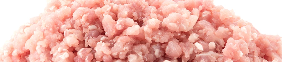 A close up image of ground turkey meat on a white background