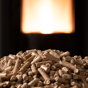 An image of wood pellets with fire on the background