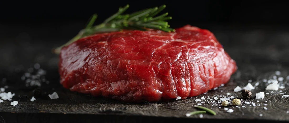 A close up image of raw lean cut steak