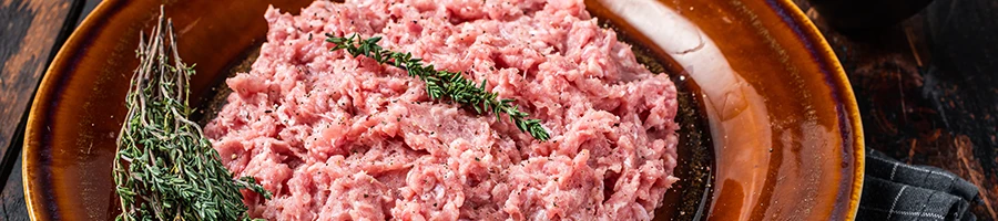 An image of ground turkey meat with herbs on top