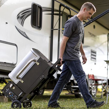 An image of a man pulling a portable pellet grill