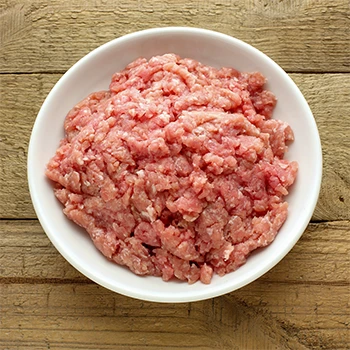 A top view image of ground turkey vs ground beef meat on a white plate