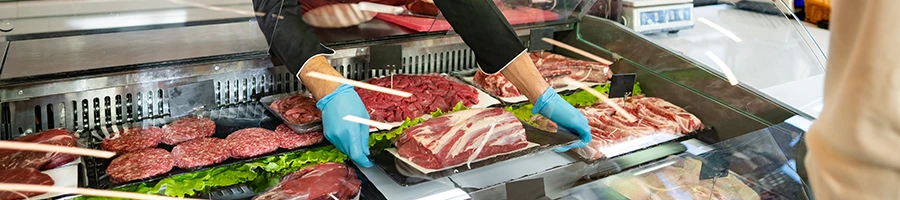 An image of a person buying meat at the butcher shop