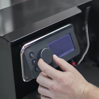 An image of a person adjusting the temperature of a pellet smoker