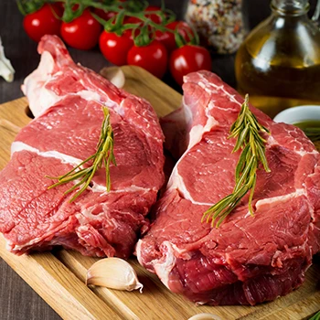 An image of two red meats on a wooden board