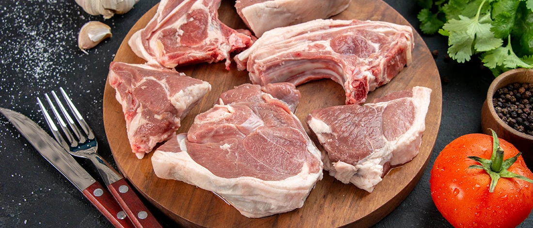 An image of brown meat on top of a wooden board