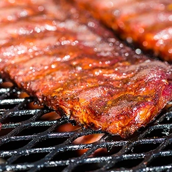 A close up shot of ribs being cooked