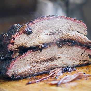 A juicy and flavorful beef brisket on a wooden board