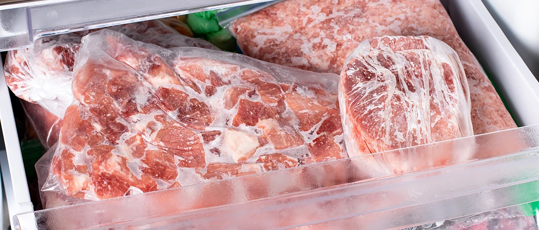 Sealed frozen meats inside a refrigerator