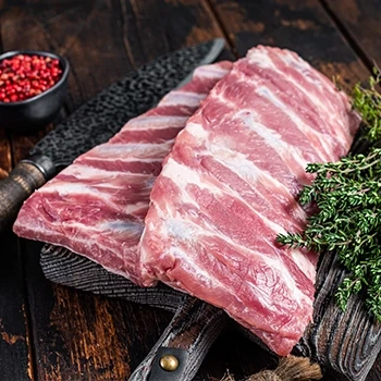 A raw baby back ribs on a wooden board