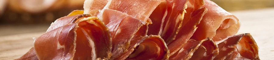 Slices of prosciutto on a wooden board
