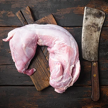 A top view of raw rabbit meat on a wooden board