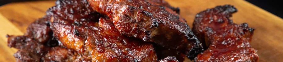 A delicious smoked country-style pork ribs on a wooden board