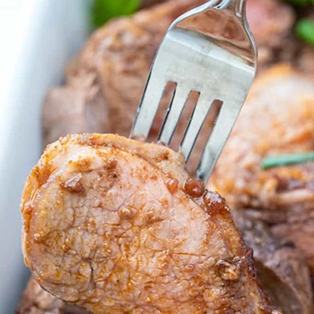 A piece of pork loin on a fork