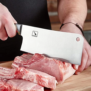 A man using a meat cleaver to cut frozen meats