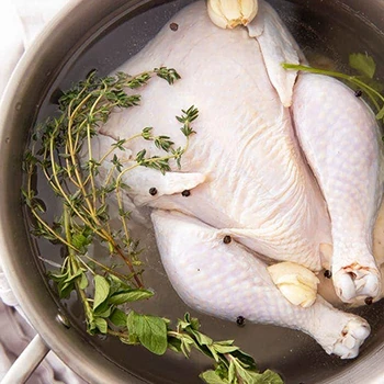 Brining and seasoning chicken meat on a cooking pot