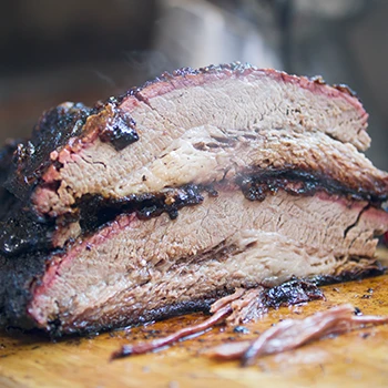 A juicy and hot brisket on a wooden board