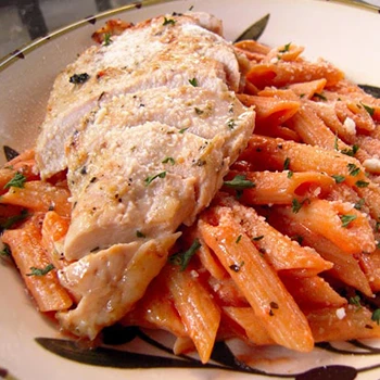 Grilled chicken on top of a pasta with vodka sauce