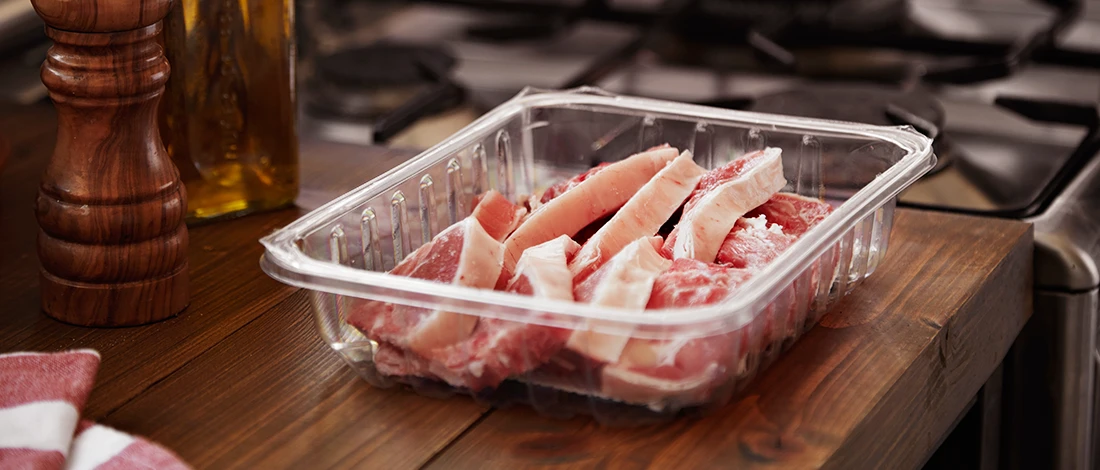 A bad pork meat on a plastic container