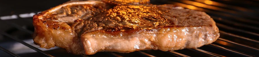 T-bone steak being cooked inside an oven