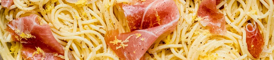 Prosciutto ham topped on a pasta dish
