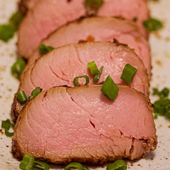 A close-up shot of medium-rare pork