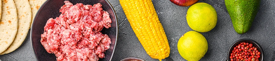 Taco meat with different ingredients on the side