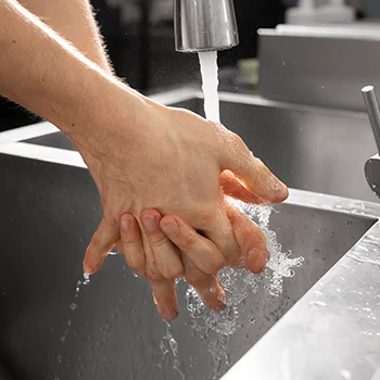 A close up shot of a person washing hands properly