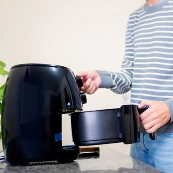 A man using an air fryer to cook eye of round steak