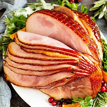 A boneless ham on a white plate that can serve per person