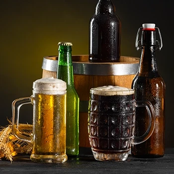 A close-up shot of beer in a mug and bottles used for spritz brisket