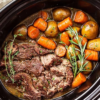 A top view of pot roast and chuck roast on a cooking pot