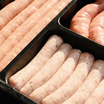 Raw sausages in a black container that might last in the fridge