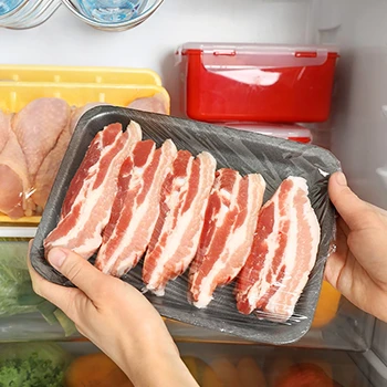 A woman puts uncooked bacon that will last in the fridge