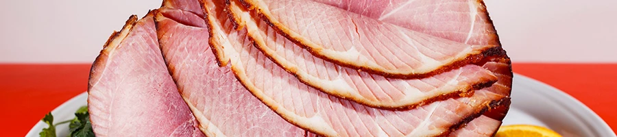 A close up shot of a ham that is sliced