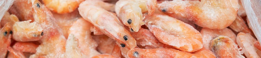 A close up shot of frozen shrimp stored inside the fridge