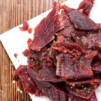 A top view of beef jerky on a white plate