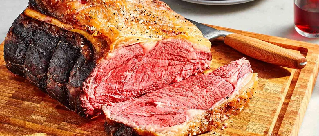 A sliced prime rib roast determining the the right serving per person