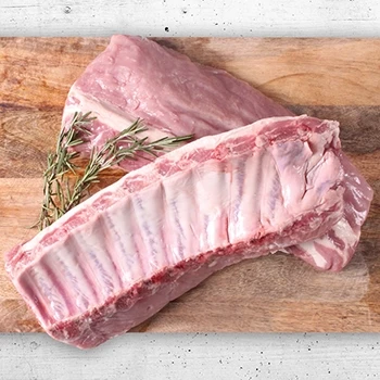 A top view of raw pork ribs on a wooden board