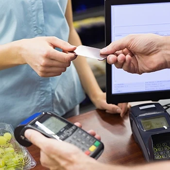 A woman paying for New York strip steak and sirloin using credit card