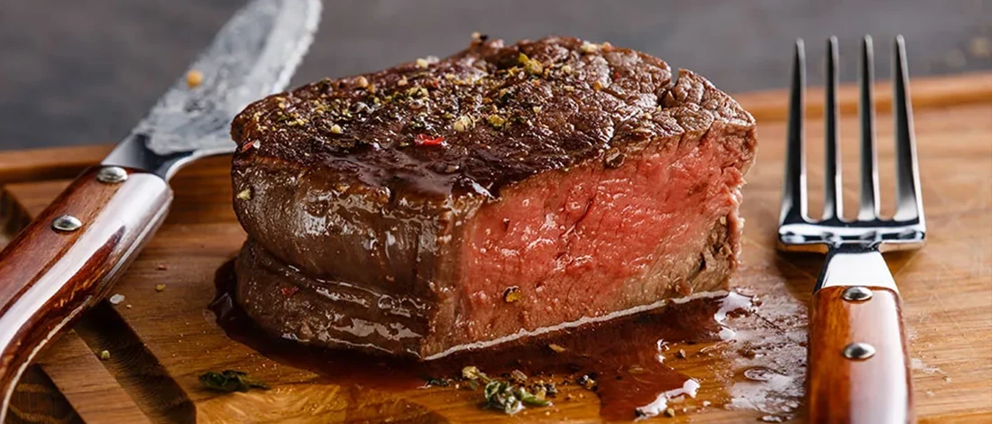 Filet mignon steak on top of a wooden board