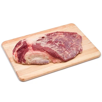 A whole-packer brisket on a wooden board